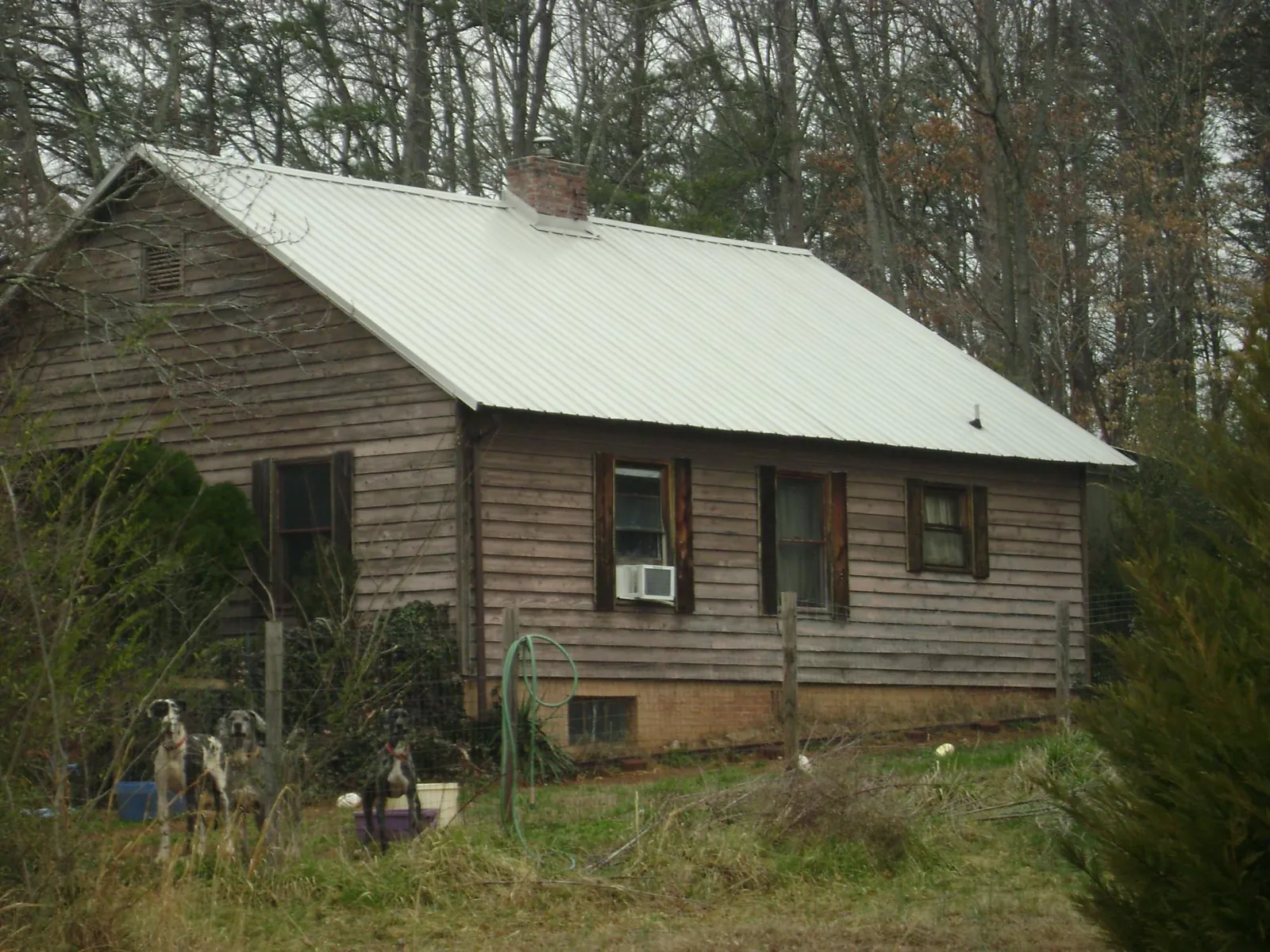White metal roof on an old wood sided farmhouse, from a Metal Roof Installation job in Starrucca